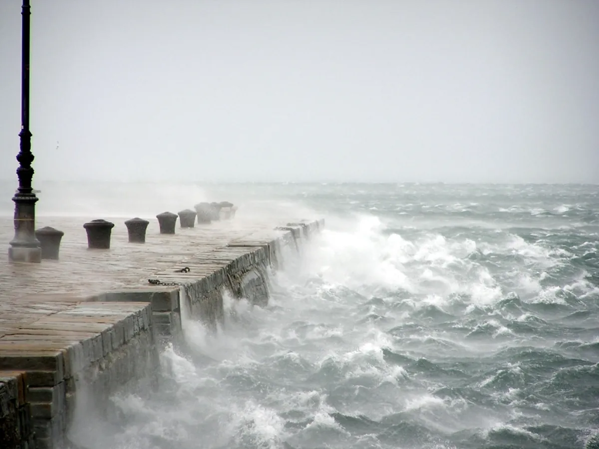 Stormy sea waves crashing on a pier as a Bay of Bengal cyclone nears landfall