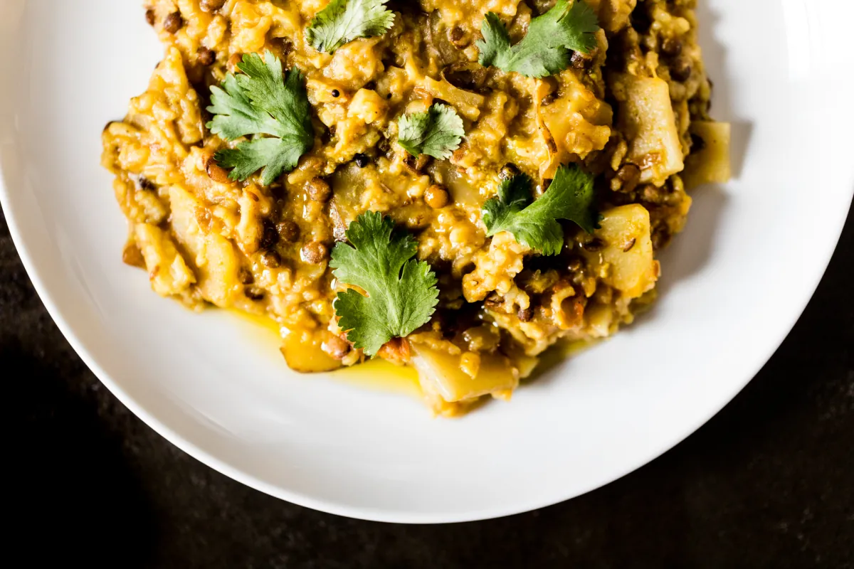 Plate of South Indian style khichdi with coriander, illustrating Chef Damu tribute
