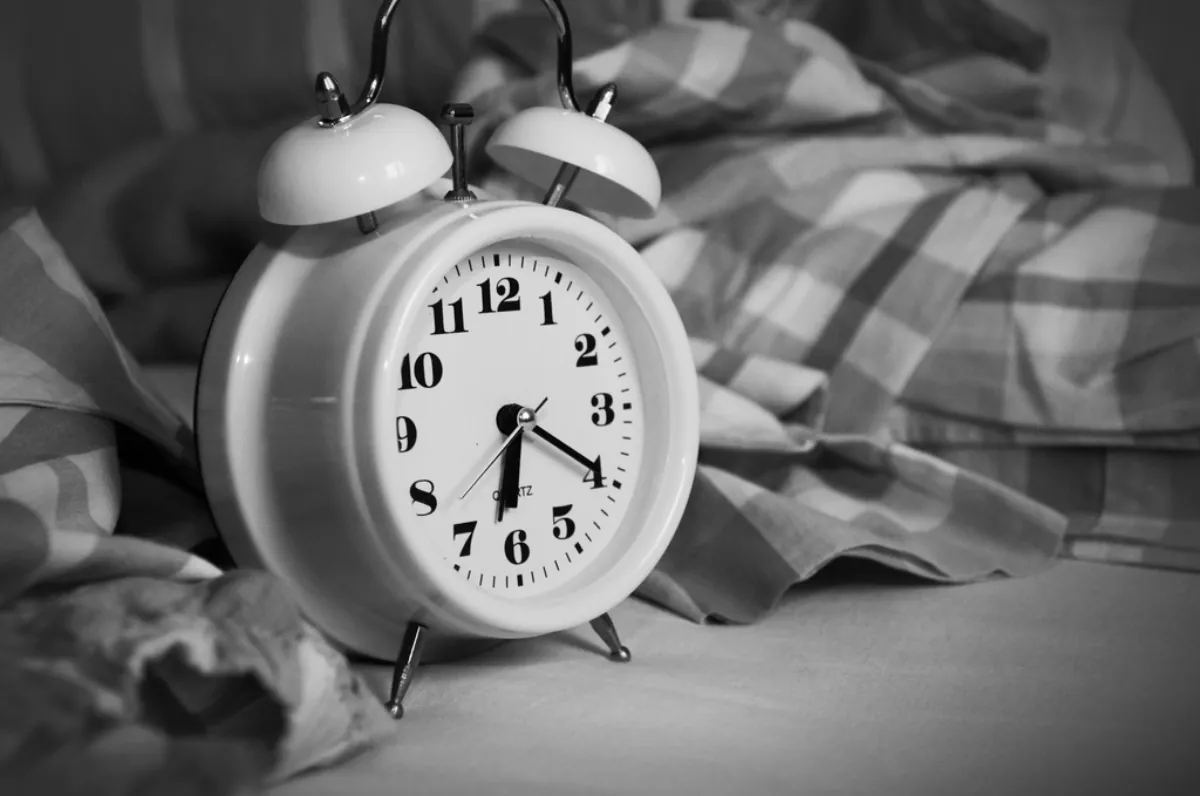 Alarm clock on a bed, illustrating circadian depression and the body clock