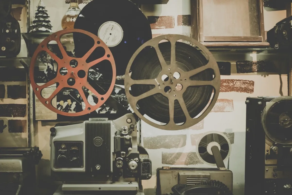 Vintage film reels and projector, illustrating the Fauzi teaser