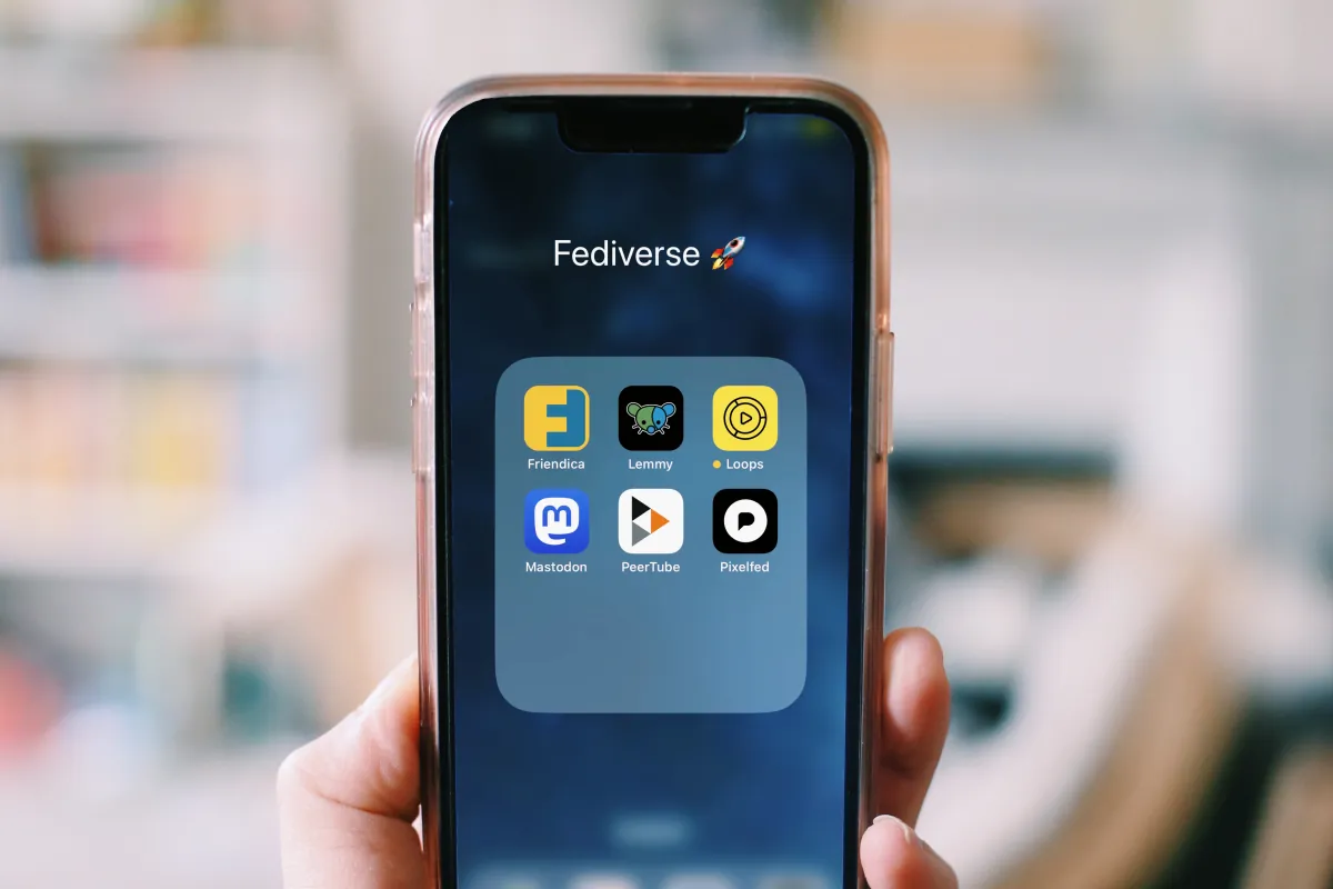 Hand holding a smartphone with apps, illustrating the Google privacy policy change