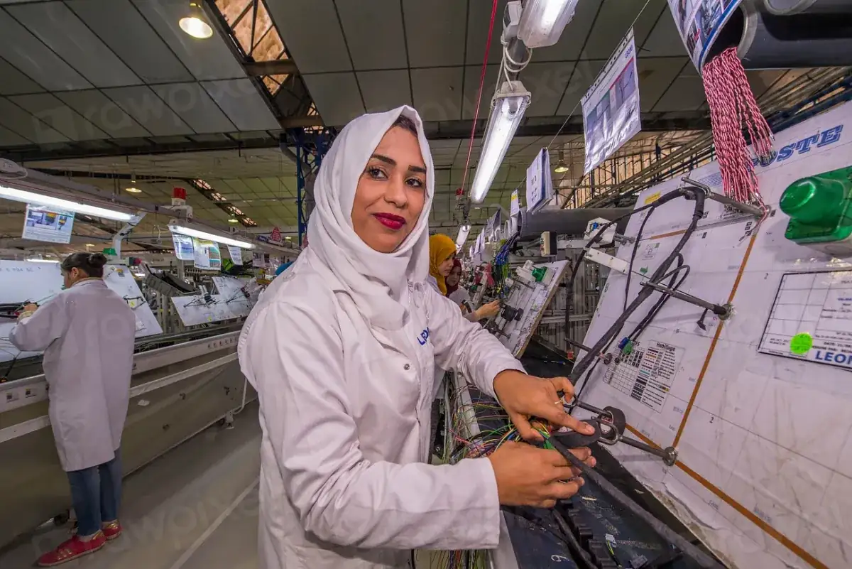 Worker on an electronics assembly line, illustrating the Indian-designed smartphone push