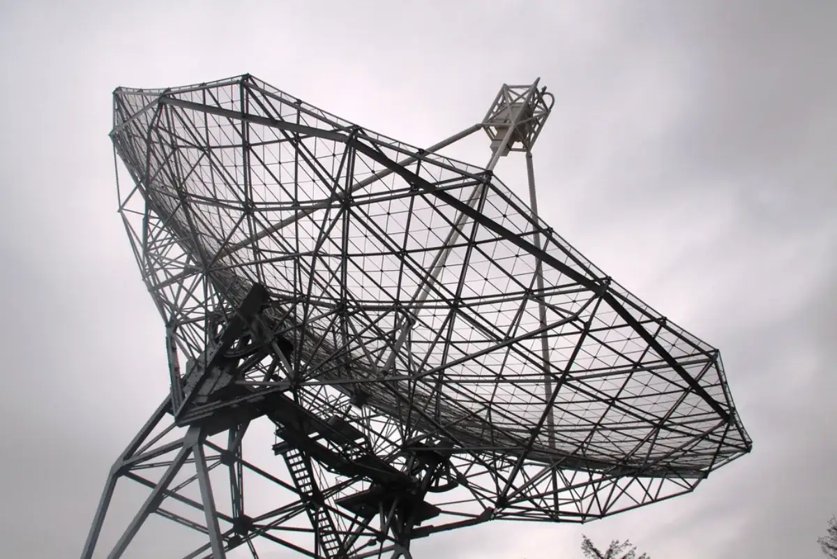 Telescope dish against a grey sky, illustrating the NASA Swift observatory mission ending