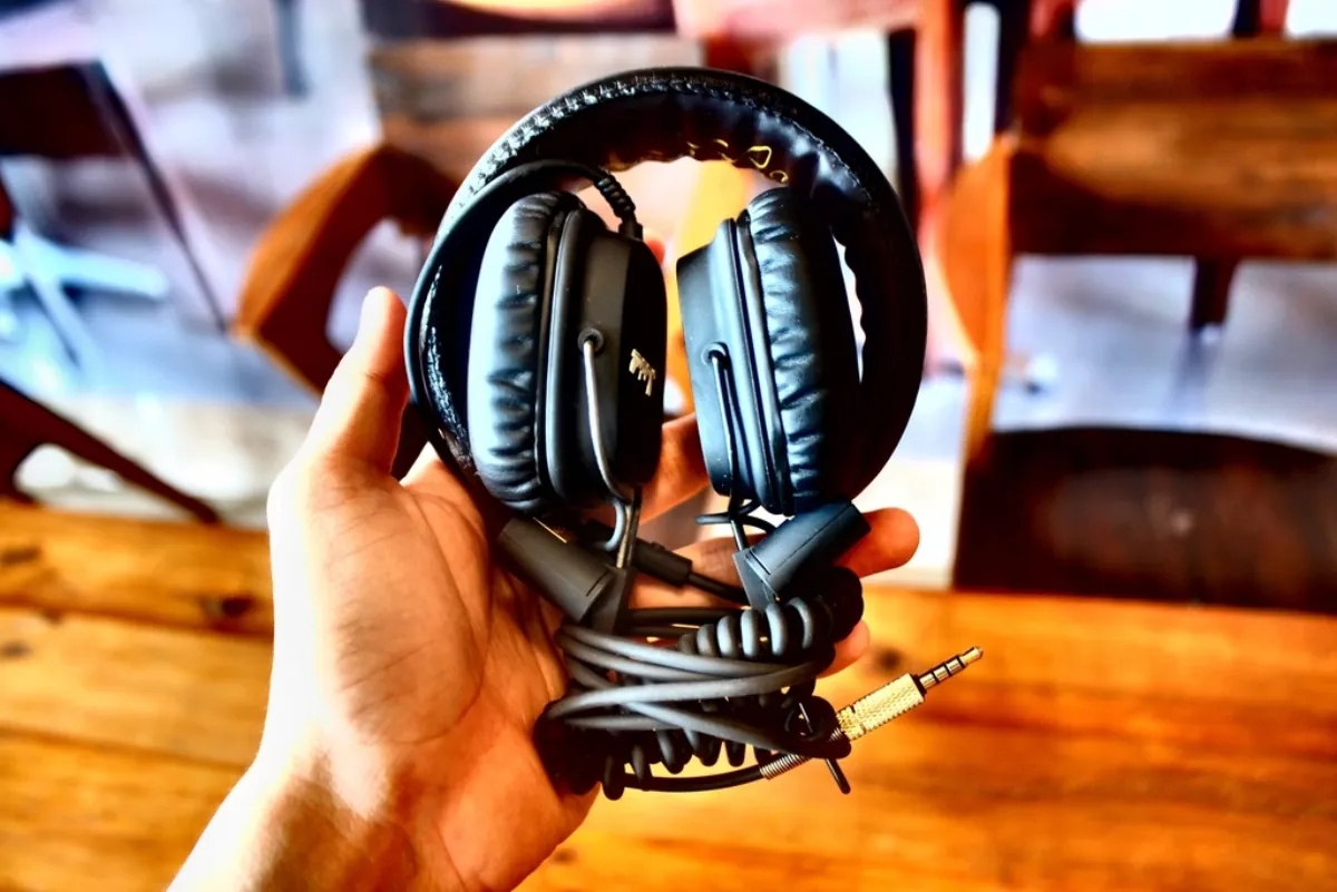Headphones held in a hand, illustrating the Ramayana song Mangal Rang release